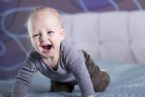 crying happy baby boy bed laughing toddler kid looking camera crawling ... (Click to enlarge)